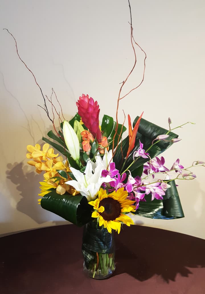 Sunlit Tropics arrangement with yellow ginger, anthurium, and palm