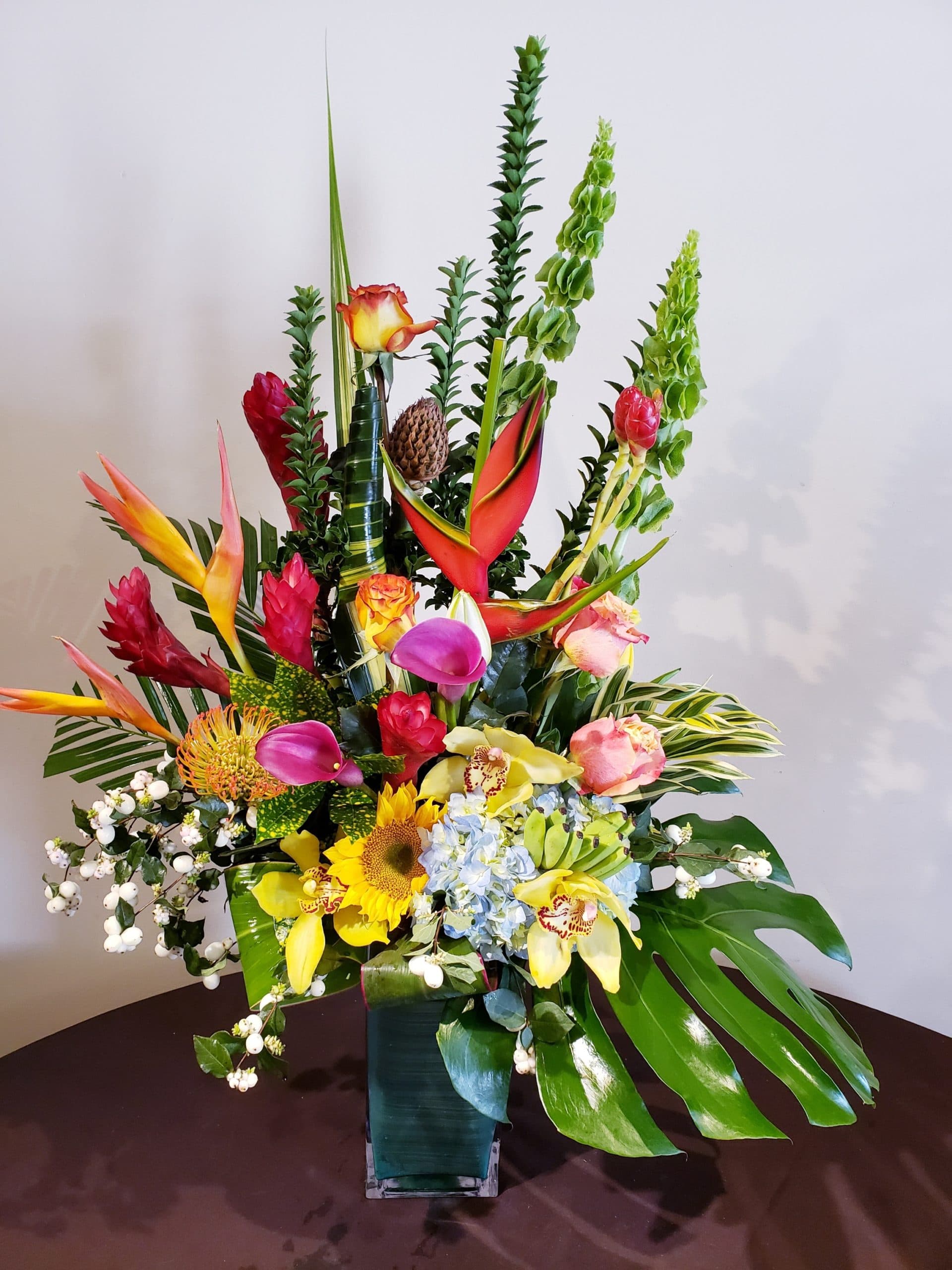 Tropical Paradise arrangement with phalaenopsis orchids and anthurium