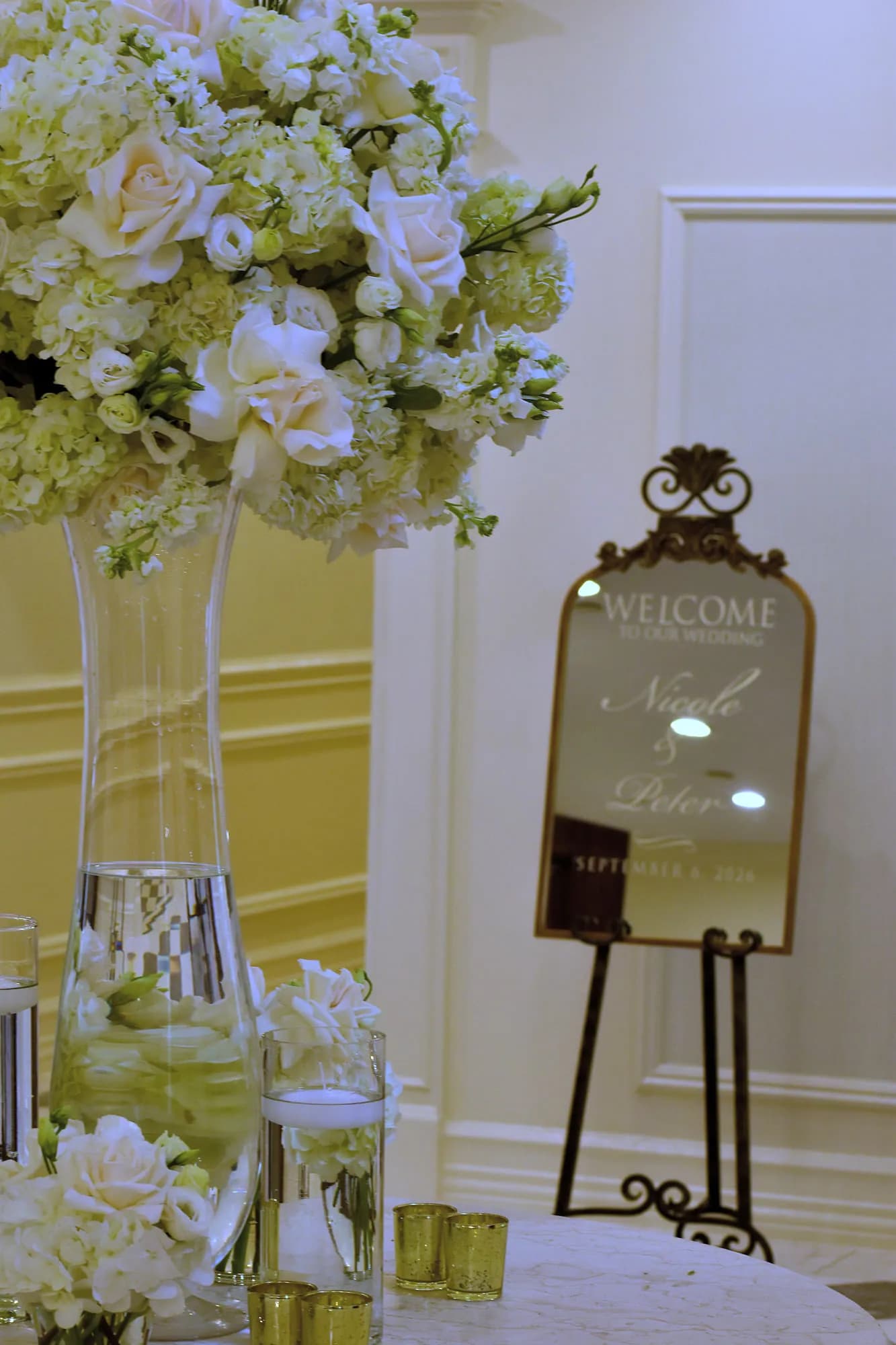 Tall foyer arrangement beside the Nicole & Peter welcome mirror