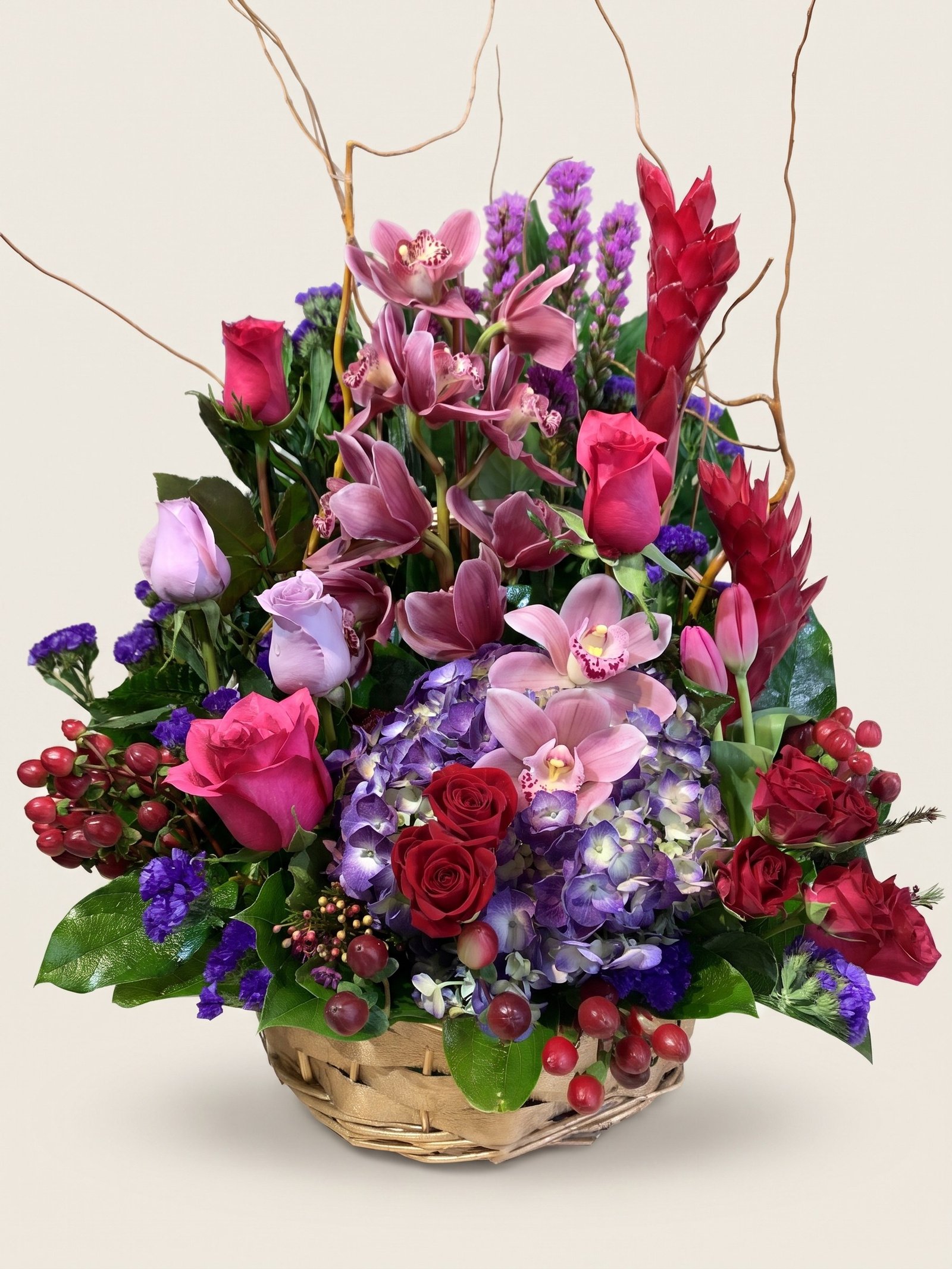Wicker basket of red ginger, pink cymbidium orchids, pink and red roses, and lavender hydrangea