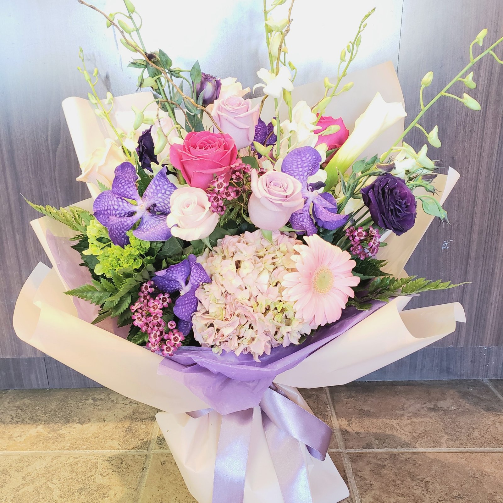 Pastel Poetry soft pastel bouquet of peach roses and ranunculus