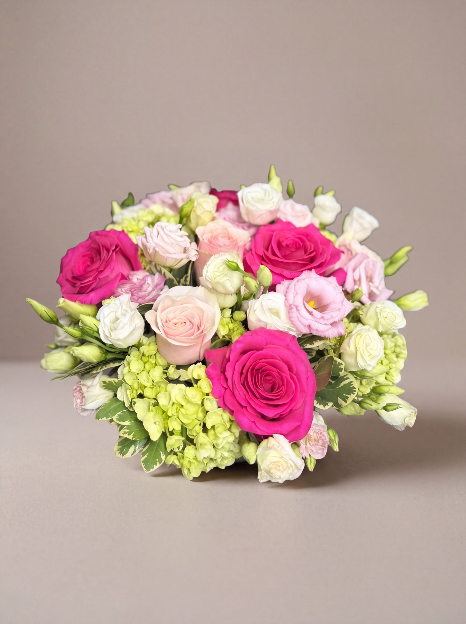 Pink Persuasion from above, hot pink roses ringed with spray roses and lisianthus